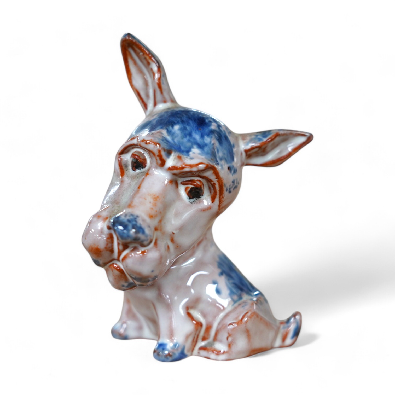 An unusual early Goebel tin glazed terracotta grotesque dog, in the style of Ida Meisinger, impressed no. KT.626., 10.5cm. Condition - good